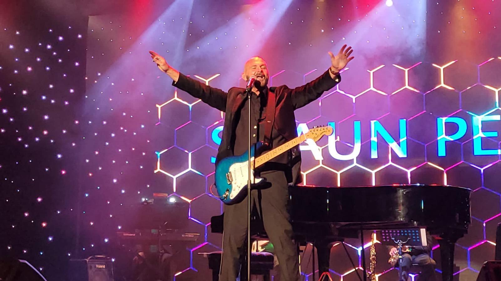 Live vocalist performing on stage at an event