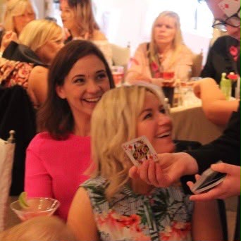 Brandon Barrett entertaining wedding guests with close-up magic