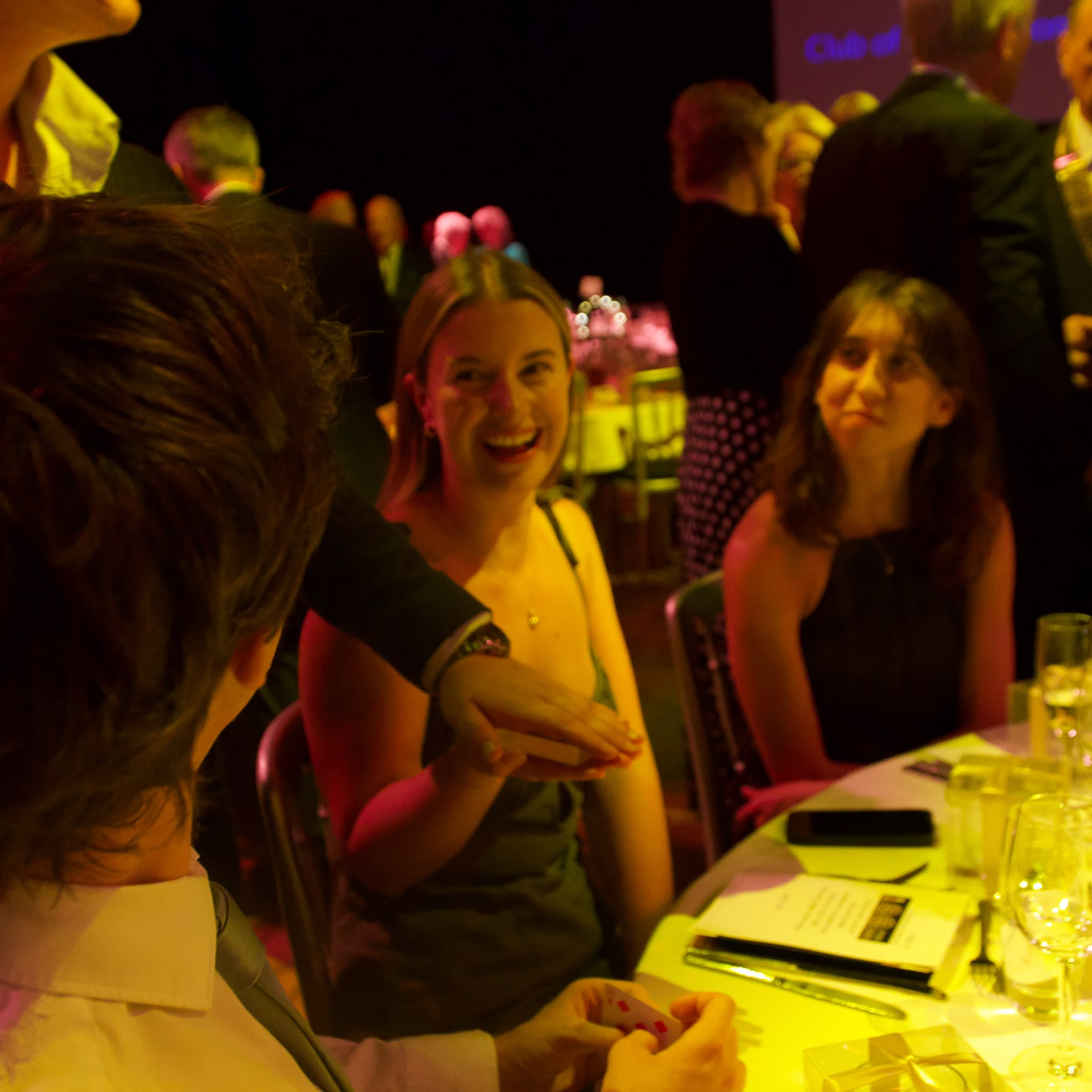 Guests reacting to Brandon Barrett's table magic