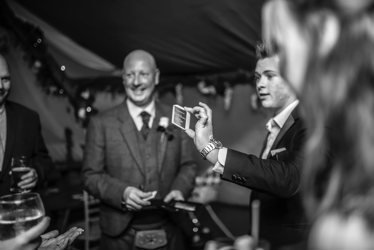 Brandon Barrett performing card magic for guests